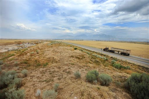 A Friday, Aug. 5, 2016 photo shows land in West Jordan, Utah, that may be purchased by FaceBook for a data center. The race between the small town of Los Lunas in New Mexico and the Salt Lake City suburb of West Jordan to entice a new Facebook data center with millions in tax breaks and subsidies is raising questions about public investments in a booming cloud-computing economy that typically brings few local jobs. (Scott G Winterton/Deseret News via AP)