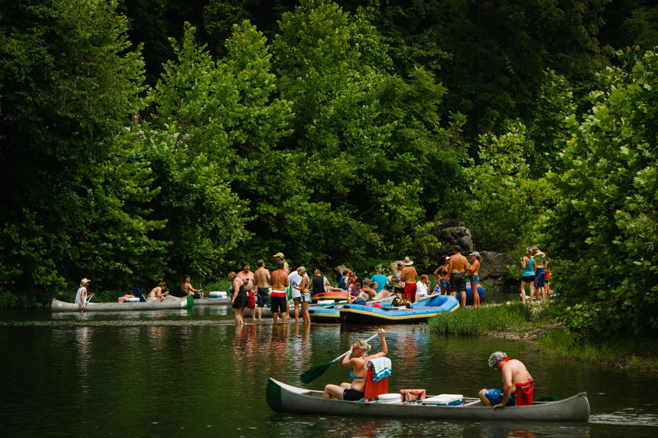 In this Aug. 3, 2013, photo boaters and floaters congregae on the Meramec River near Steelville, Mo. A murder case that will hinge on claims of self-defense and whether a property owner had the right to shoot a canoer who may have intruded on his land is the latest to put a spotlight on “castle doctrine” laws, which allow the use of deadly force to protect property. Missouri is among at least 30 states that have enacted the statues, which supporters say protect gun rights but others insist promote vigilantism. (AP Photo/The St. Louis Post-Dispatch, Erik M. Lunsford) EDWARDSVILLE INTELLIGENCER OUT; THE ALTON TELEGRAPH OUT