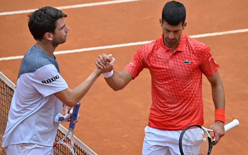 Cameron Norrie (left) and Novak Djokovic - Watch: Cameron Norrie smashes ball into back of Novak Djokovic – and gets death stare response - Getty Images/Tiziana Fabi