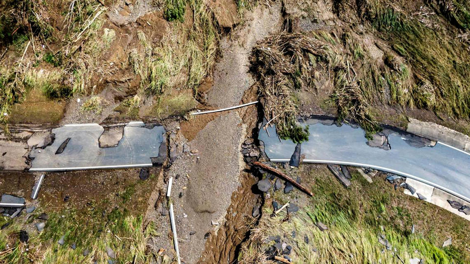 Road bisected by flood debris. (Miami Herald / TNS)