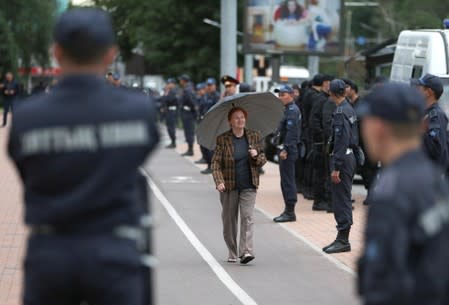 Kazakh law enforcement officers stand guard during a rally held by opposition supporters in Almaty