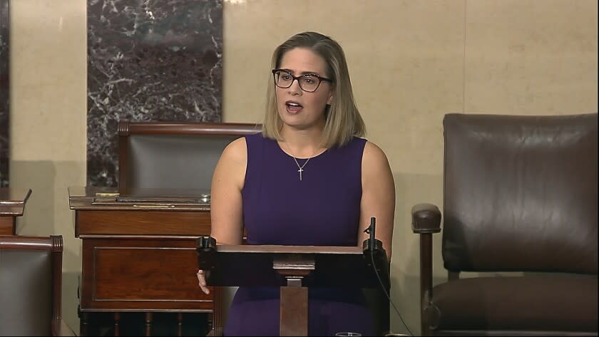 In this image from Senate Television, Sen. Kyrsten Sinema, D-Ariz., speaks on the floor of the U.S. Senate on Thursday, Jan. 13, 2022. President Joe Biden is set to meet privately with Senate Democrats at the Capitol, a visit intended to deliver a jolt to the party's long-stalled voting and elections legislation. Before he arrived Sinema blunted the bill's chances further, declaring she could not support a "short sighted" rules change to get past a Republican blockade. (Senate Television via AP)