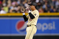 Arizona Diamondbacks'Josh Rojas motions to his dugout after hitting a double against the St. Louis Cardinals during the fourth inning of a baseball game, Friday, Aug. 19, 2022, in Phoenix. (AP Photo/Matt York)