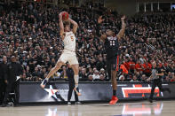 Texas' Devin Askew (5) catches the ball around Texas Tech's Bryson Williams (11) during the first half of an NCAA college basketball game on Tuesday, Feb. 1, 2022, in Lubbock, Texas. (AP Photo/Brad Tollefson)