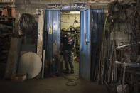 A Palestinian employee stands in a workshop at the Pepsi bottling plant in Gaza City, Monday, June 21, 2021. Israel on Monday eased some restrictions on the Gaza Strip however the Pepsi factory announced today that it was closing and laying off workers because raw materials needed to stay in business are still not coming. (AP Photo/Felipe Dana)