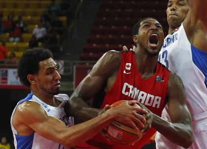 Canada's Tristan Thompson (C) goes for a basket against Dominican Republic's Juan Coronado (L) and Eulis Baez at the FIBA Americas Championship basketball game in Caracas September 7, 2013. REUTERS/Carlos Garcia Rawlins (VENEZUELA - Tags: SPORT BASKETBALL)