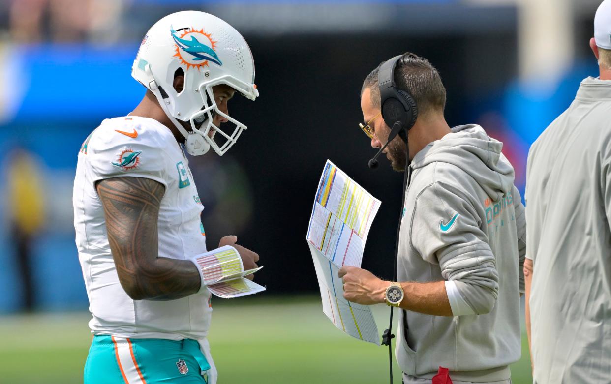 Dolphins coach Mike McDaniel and quarterback Tua Tagovailoa talk strategy.