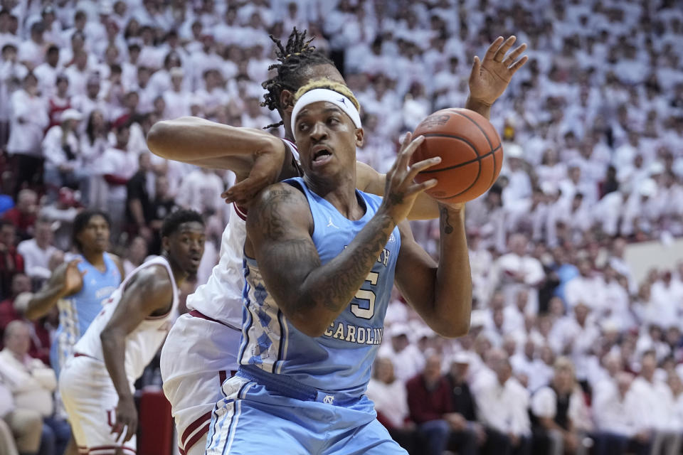 CORRECTS CITY TO BLOOMINGTON, INSTEAD OF INDIANAPOLIS - North Carolina forward Armando Bacot (5) drives to the basket past Indiana forward Malik Reneau, left, during the first half of an NCAA college basketball game in Bloomington, Ind., Wednesday, Nov. 30, 2022. (AP Photo/Darron Cummings)