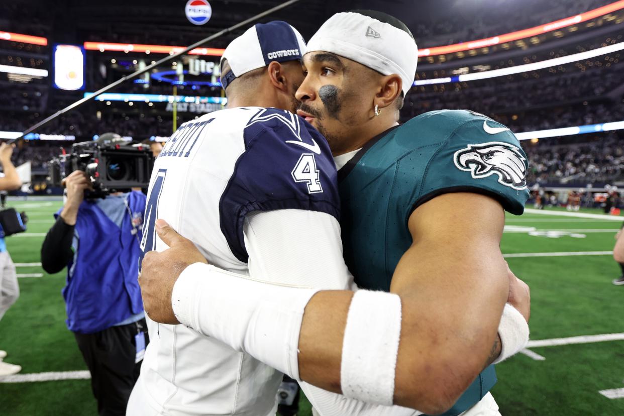 Dallas Cowboys quarterback Dak Prescott hugs Philadelphia Eagles quarterback Jalen Hurts after the Sunday game at AT&T Stadium in Arlington, Texas.