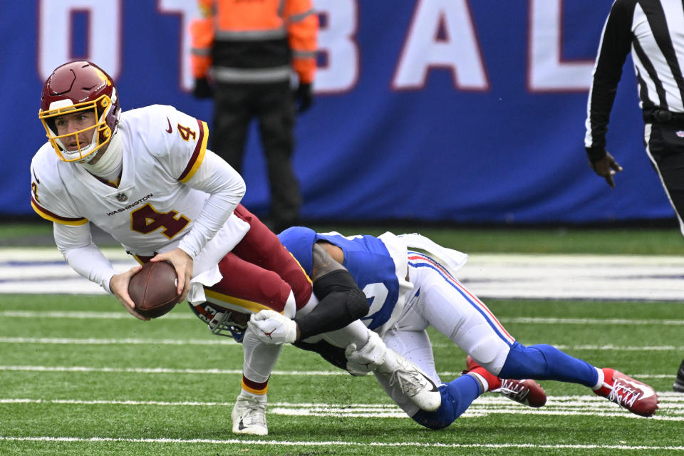 Washington Football Team quarterback Taylor Heinicke (4) is tackled by New York Giants safety Logan Ryan (23) during the second quarter of an NFL football game, Saturday, Jan. 9, 2021, in East Rutherford, N.J. (AP Photo/Bill Kostroun)