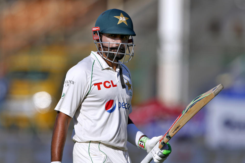 Pakistan's Babar Azam walks back to pavilion after his dismissal on 196 runs on the fifth day of the second test match between Pakistan and Australia at the National Stadium in Karachi Pakistan, Wednesday, March 16, 2022. (AP Photo/Anjum Naveed)