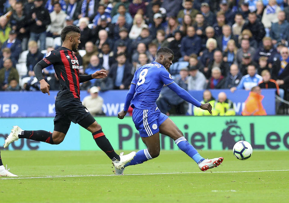 Leicester City's Kelechi Iheanacho, right, scores his side's first goal of the game against Huddersfield Town during their English Premier League soccer match at the King Power Stadium in Leicester, England, Saturday Sept. 22, 2018. (Nigel French/PA via AP)