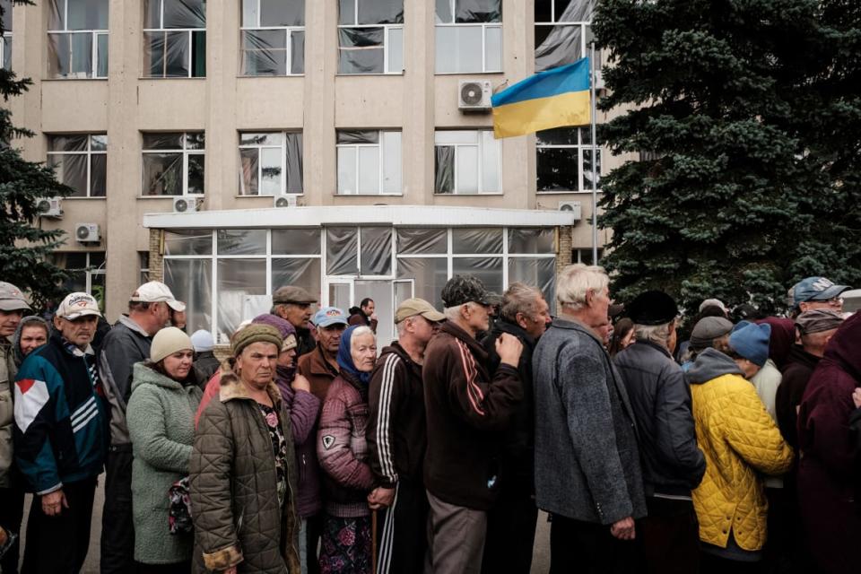 <div class="inline-image__caption"><p>People wait in line during food and medical distribution in the recently retaken town of Lyman in the Donetsk region on Oct. 5, 2022.</p></div> <div class="inline-image__credit">Yasuyoshi Chiba/AFP via Getty</div>