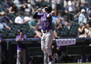 Colorado Rockies' Trevor Story points up after hitting a solo home run on a pitch from Seattle Mariners starting pitcher Justus Sheffield during the fourth inning a baseball game, Wednesday, June 23, 2021, in Seattle. (AP Photo/John Froschauer)