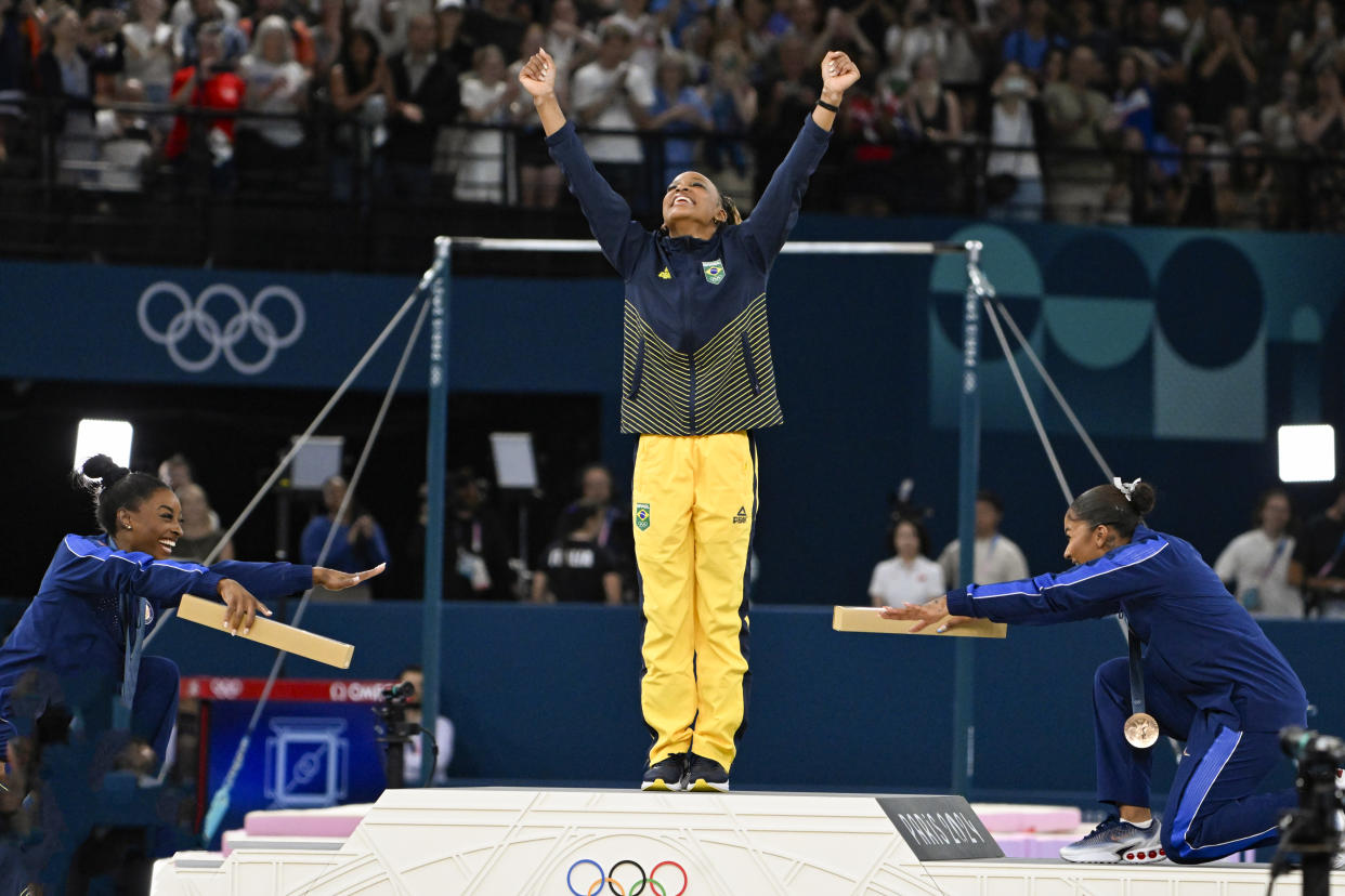 PARIS, FRANCE - AUGUST 5: Simone Biles (L) and Jordan Chiles (R) of Team United States congratulate Rebeca Andrade (C) of Team Brazil for winning Gold Medal in the Women's Floor Exercise Final on day ten of the Olympic Games Paris 2024 at Bercy Arena on August 5, 2024 in Paris, France. (Photo by André Ricardo/Eurasia Sport Images/Getty Images)