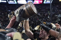 Purdue players lift the Old Oaken Bucket after they defeated Indiana 44-7 in an NCAA college football game, Saturday, Nov. 27, 2021, in West Lafayette, Ind.(AP Photo/Darron Cummings)