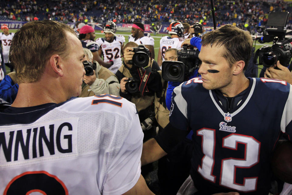 FILE - Denver Broncos quarterback Peyton Manning, left, and New England Patriots quarterback Tom Brady meet after the Patriots' 31-21 win in their NFL football game on Oct. 7, 2012, in Foxborough, Mass. Brady, the seven-time Super Bowl winner with New England and Tampa Bay, announced his retirement from the NFL on Wednesday, Feb. 1, 2023 exactly one year after first saying his playing days were over. He leaves the NFL with more wins, yards passing and touchdowns than any other quarterback. (AP Photo/Steven Senne, File)