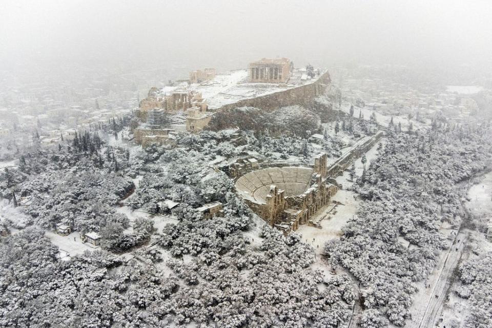 The Parthenon temple is seen atop the Acropolis during heavy snowfall in Athens on Monday (REUTERS)