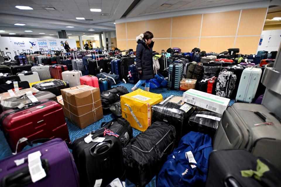 A passenger searches for her luggage two days after her flight was cancelled due to a storm at Vancouver International Airport in Richmond, British Columbia (Reuters)