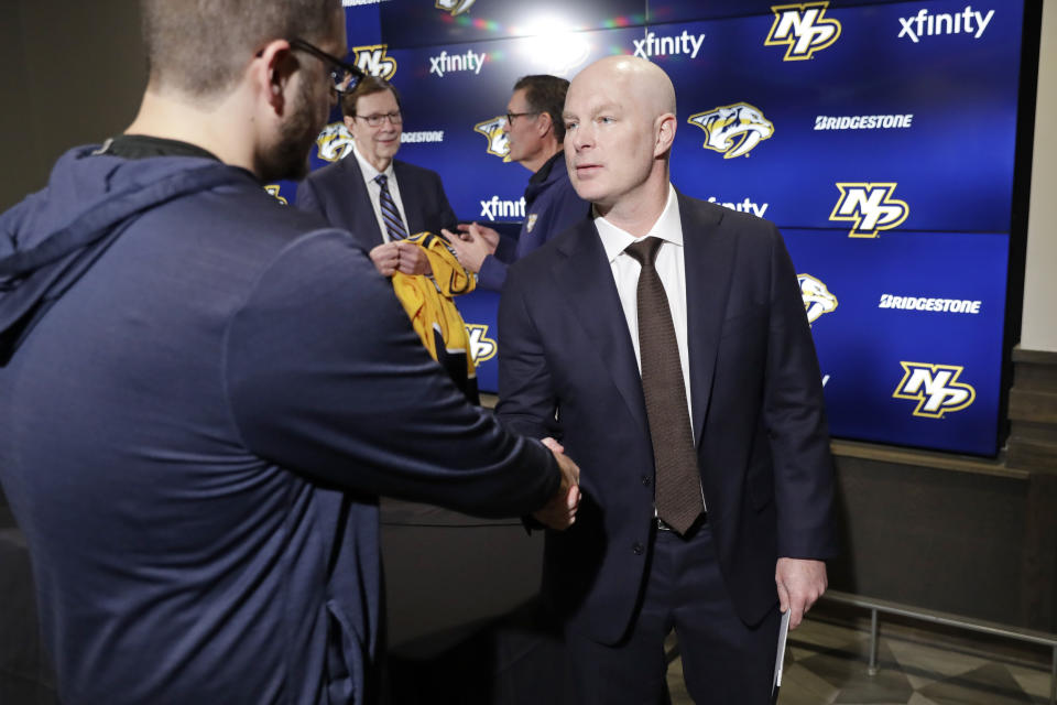 John Hynes, right, greets people after a news conference where he was introduced as the Nashville Predators' new NHL hockey team head coach Tuesday, Jan. 7, 2020, in Nashville, Tenn. (AP Photo/Mark Humphrey)