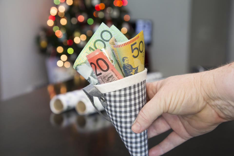 A Christmas cone filled with Australian money, $100, $50, $20