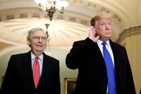 FILE PHOTO: U.S. President Donald Trump listens to a question from reporters next to Senate Majority Leader Mitch McConnell (R-KY) as he arrives for a closed Senate Republican policy lunch on Capitol Hill in Washington, U.S., March 26, 2019. REUTERS/Brendan McDermid/File Photo