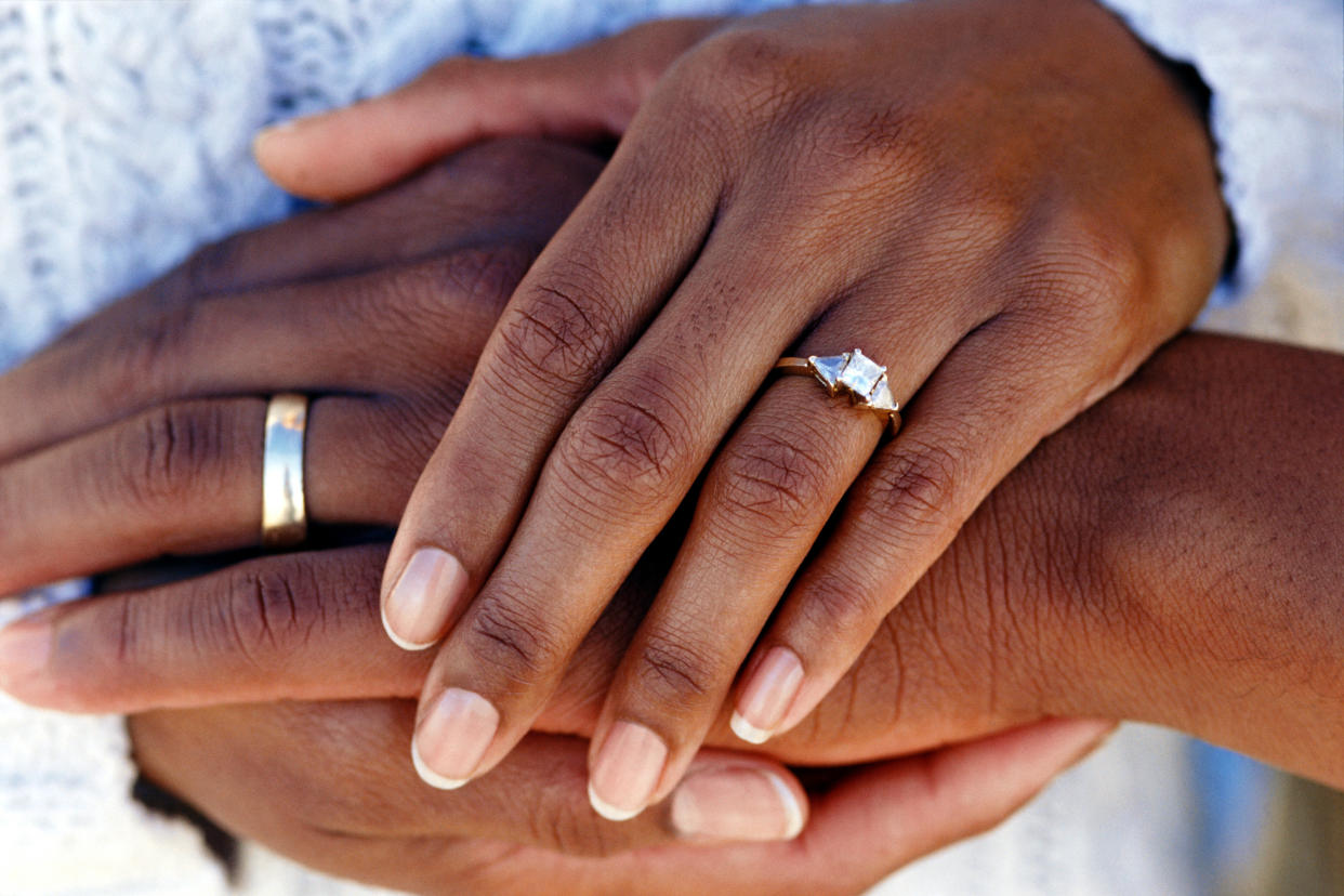 Hands of married couple wearing wedding rings (Photo: Thinkstock via Getty Images)