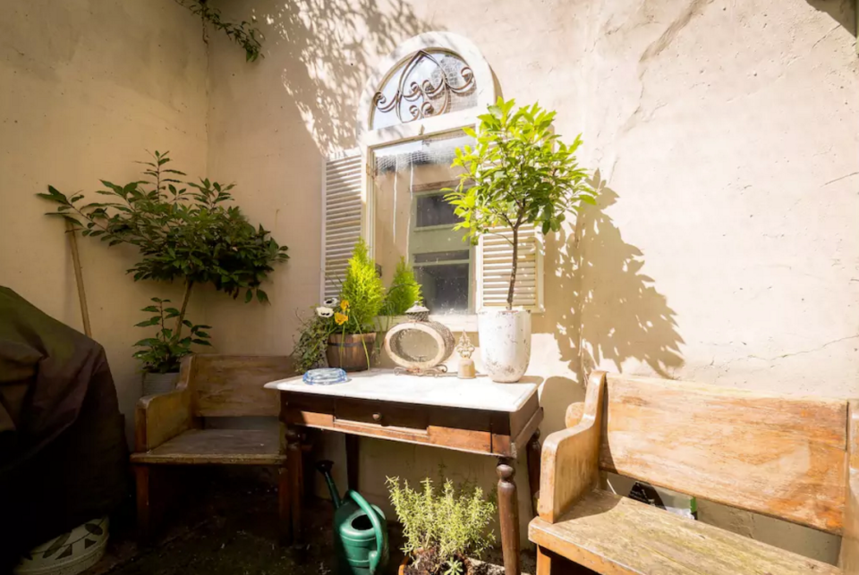 <p>The outside also has a picturesque courtyard. (Airbnb) </p>