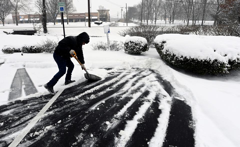 Carlos Vazquez shovels the parking lot at Brentwood Medical Center on Franklin Road on Monday, Jan. 15, 2024, in Brentwood, Tenn. The first winter of 2024 hit Middle Tennessee and snowfall is expected to continue until Tuesday.