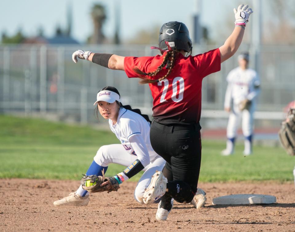 Kimball's Kaeliana DePerio, left, turns to tag Lincoln's Mallory Wagner out at second during a girls varsity softball game at Kimball High in Tracy on Mar. 7, 2024. Pamplona was ruled safe. Kimball won 13-7.