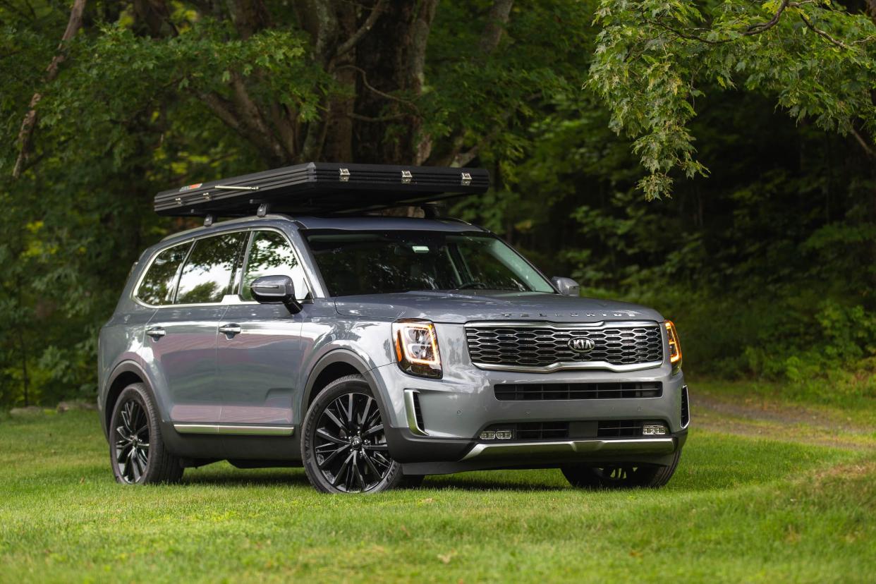 A gray 2020 Kia Telluride on a green lawn.