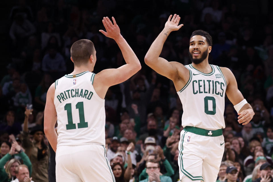 Boston Celtics forward Jayson Tatum (0) and guard Payton Pritchard (11) celebrate after a basket during the first half of a preseason NBA basketball game against the Philadelphia 76ers, Sunday, Oct. 8, 2023, in Boston. (AP Photo/Mary Schwalm)