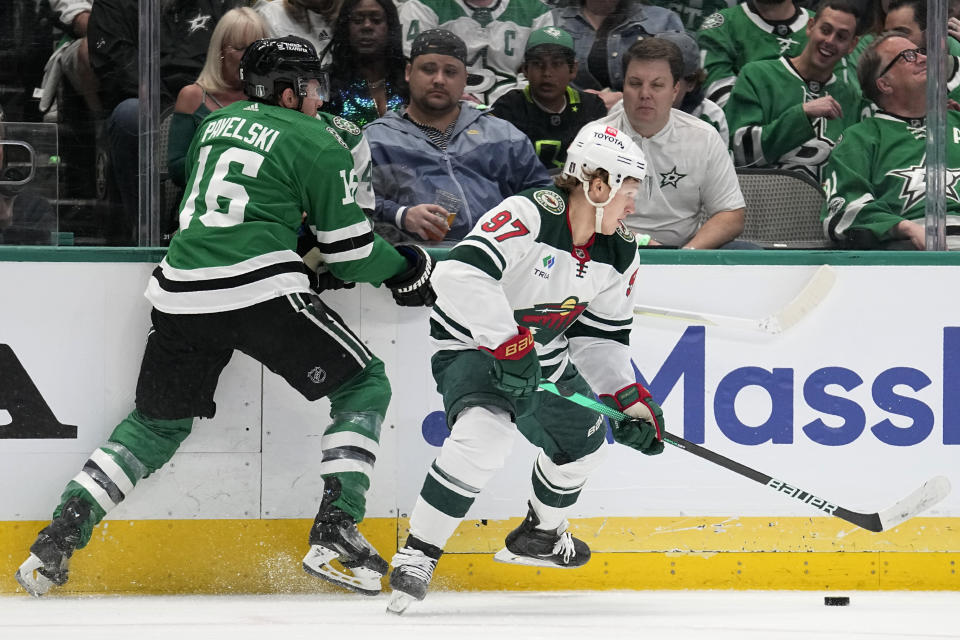 Dallas Stars center Joe Pavelski (16) and Minnesota Wild left wing Kirill Kaprizov (97) compete for control of the puck during the first period of Game 1 of an NHL hockey Stanley Cup first-round playoff series, Monday, April 17, 2023, in Dallas. (AP Photo/Tony Gutierrez)
