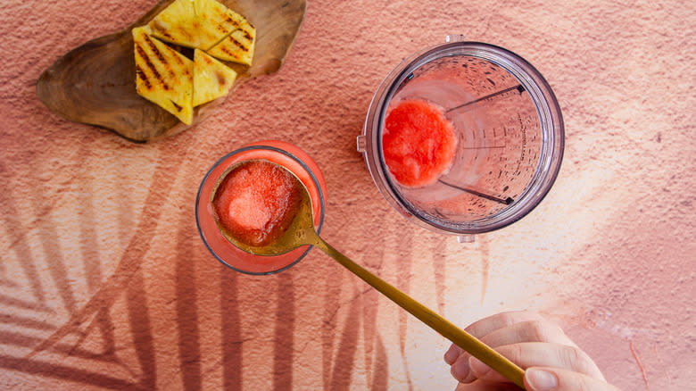 pink tropical blended frozen cocktail in blender