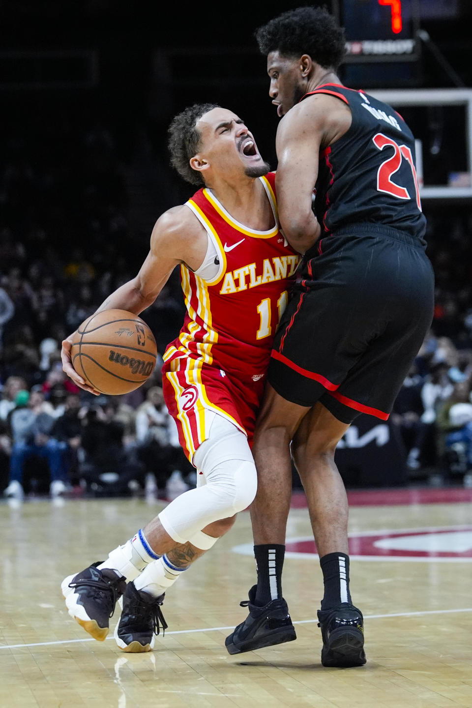 Atlanta Hawks guard Trae Young (11) is fouled by Toronto Raptors forward Thaddeus Young (21) in the second half of an NBA basketball game Sunday, Jan. 28, 2024, in Atlanta. (AP Photo/John Bazemore)