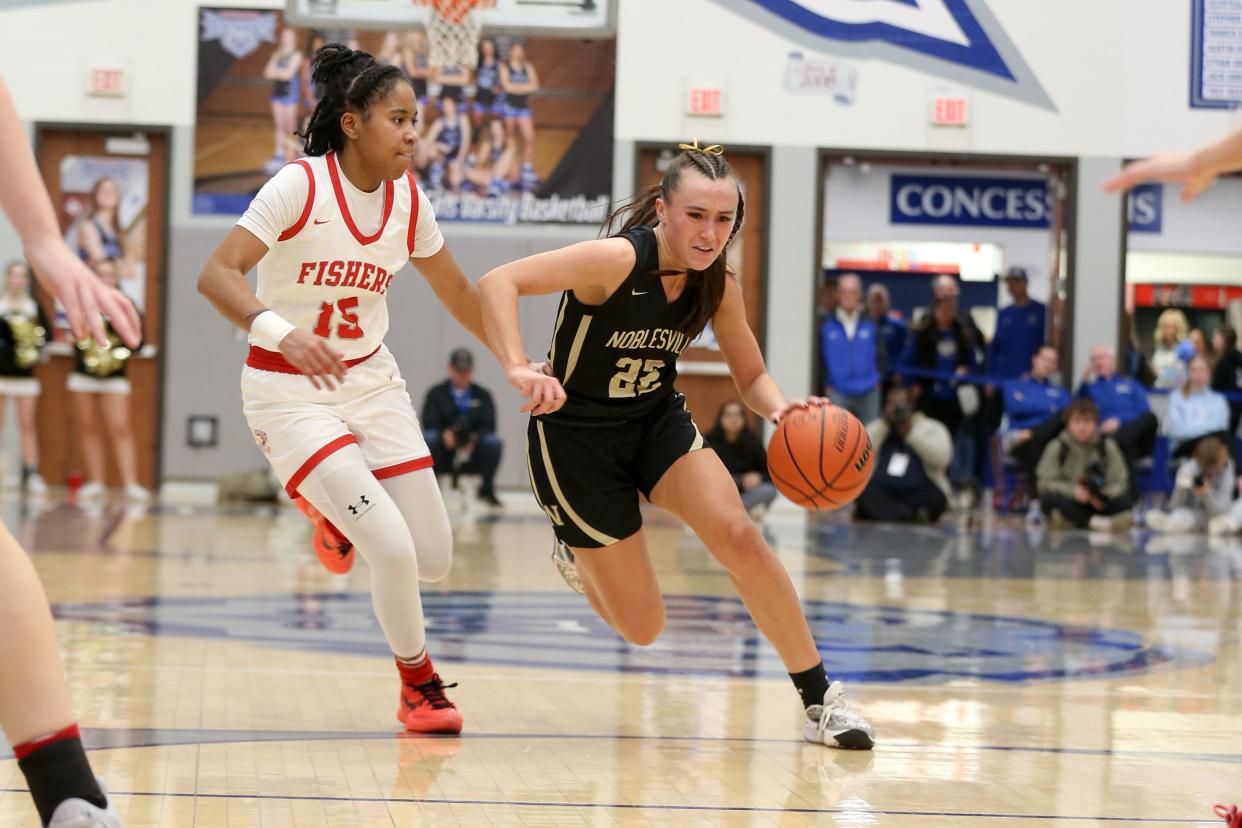 Noblesville Reagan Wilson (22) tries to get around Fishers Talia Harris (15) to the basket as Noblesville takes on Fishers High School in the S8 IHSAA Class 4A Girls Basketball State Semi-finals; Feb 2, 2024; Fishers, IN, USA; at Hamilton Southeastern High School.