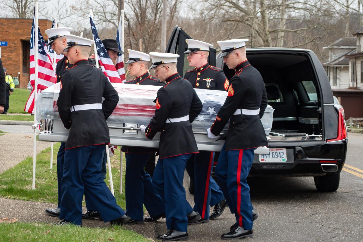 Members of the U.S. Marine Corp Lima Company, 3rd Battalion, 25th Marines carry the body of Gunnery Sergeant James Speedy from the hearse into the Thorn-Black Funeral home in Cambridge on Friday.