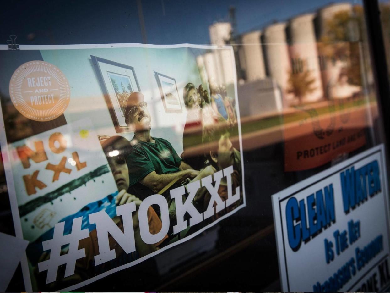 Signs against the proposed Keystone XL pipeline are taped to the window a hardware store on 11 October 2014 in Polk, Nebraska: Getty