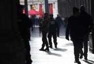 Soldiers and police patrol a nearly empty shopping mall as the Belgian capital remains on the highest possible alert level, in Brussels on November 23, 2015