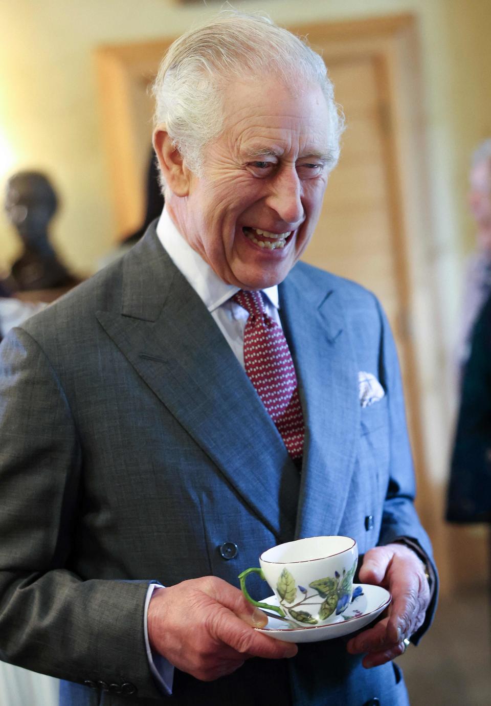 King Charles III has a cup of tea as he attends his 75th birthday party at Highgrove House on Nov. 13.