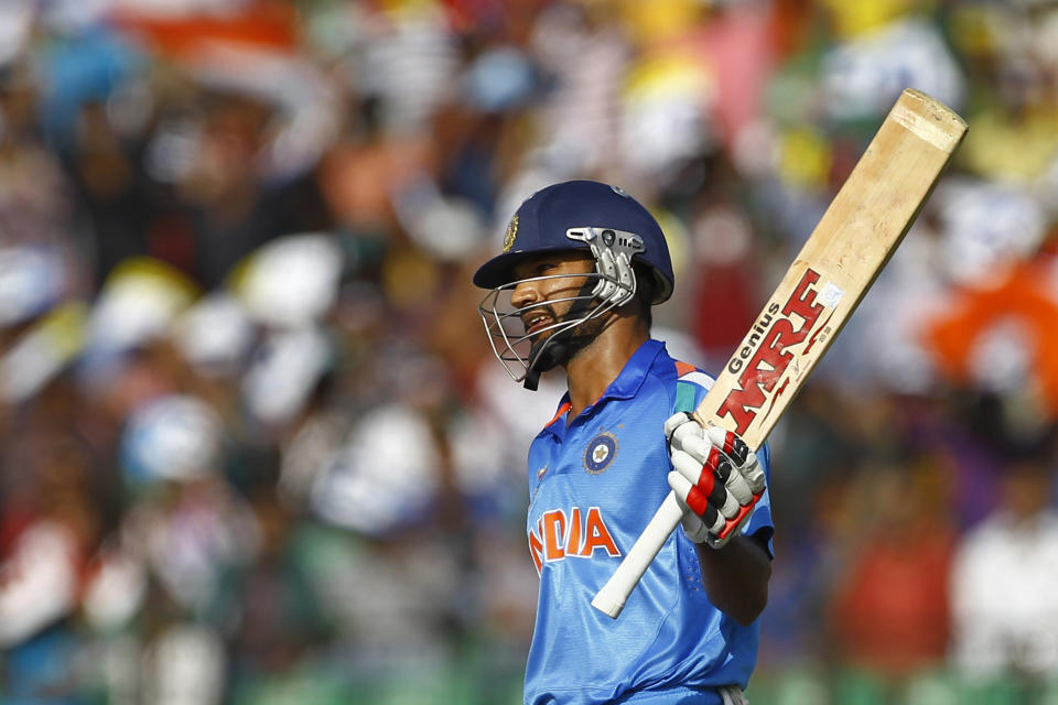 India’s Shikhar Dhawan acknowledges the crowed after scoring fifty runs during the Asia Cup one-day international cricket tournament against Sri Lanka in Fatullah, near Dhaka, Bangladesh, Friday, Feb. 28, 2014. (AP Photo/A.M. Ahad)