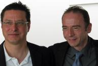 German Dr. Gero Hutter, left, and Timothy Ray Brown pose for a picture after Hutter discussed his treatment of Brown at a symposium on gene therapy cures at Washington University on Wednesday, Sept. 12, 2012, in St. Louis. Brown was diagnosed with HIV in 1995. In 2007 he had a blood gem cell transplant to treat leukemia using a donor with a rare gene mutation that provides natural resistance to HIV. Hutter says that resistance transferred to Brown and that enough time has passed to say without hesitation that he is cured of HIV. (AP Photo/Jim Salter)