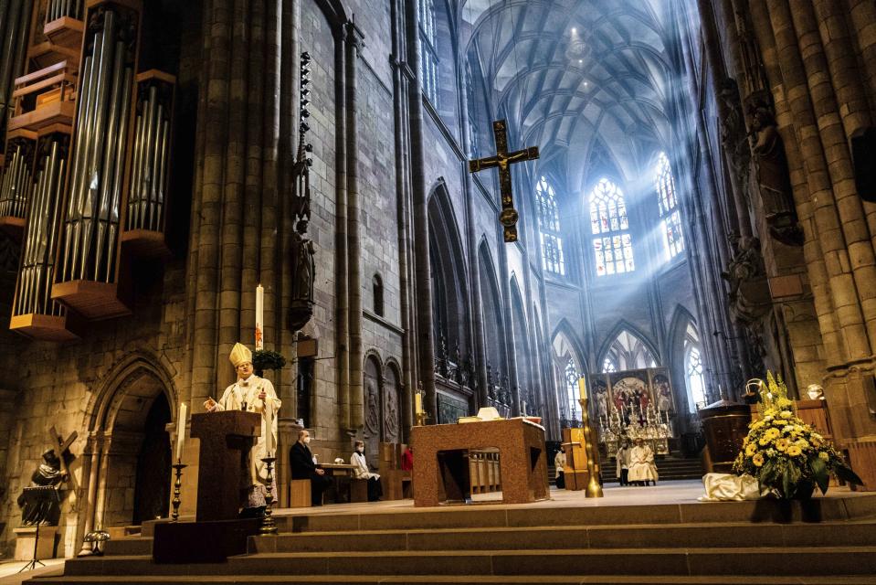 Archbishop Stephan Burger speaks to the faithful during the Pontifical Mass for Easter Sunday in Freiburg Cathedral in Freiburg, Germany, Sunday, April 4, 2021. (Philipp von Ditfurth/dpa via AP)