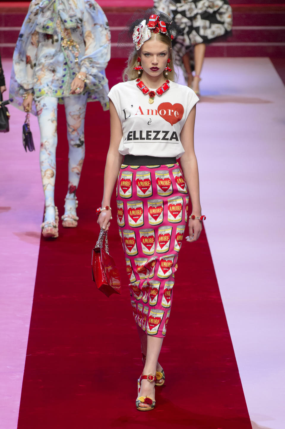 <p><i>Model wears a graphic skirt decorated with Warhol-style cans from the SS18 Dolce & Gabbana collection. (Photo: ImaxTree) </i></p>