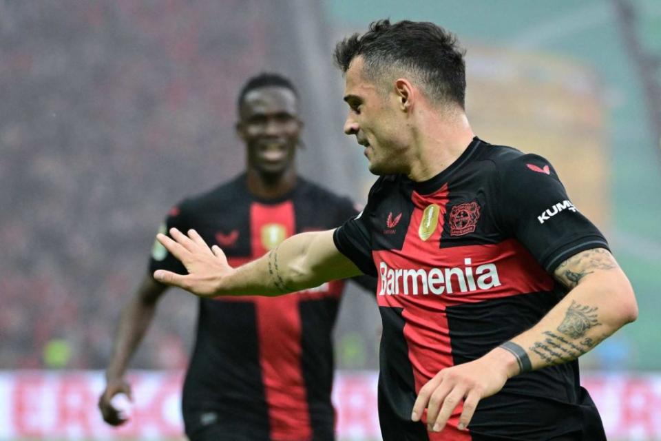 Bayer Leverkusen's Swiss midfielder #34 Granit Xhaka celebrates scoring the opening goal with his teammates during the German Cup (DFB-Pokal) final football match between 1 FC Kaiserslautern and Bayer 04 Leverkusen at the Olympic Stadium in Berlin on May 25, 2024. (Photo by TOBIAS SCHWARZ/AFP via Getty Images)