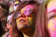 A reveler is covered in colored corn starch during the 2014 Festival of Colors, Holi Celebration at the Krishna Temple Saturday, March 29, 2014, in Spanish Fork, Utah. Nearly 70,000 people are expected to gather starting Saturday at a Sri Sri Radha Krishna Temple in Spanish Fork for the annual two-day festival of colors. Revelers gyrate to music and partake in yoga during the all-day festival, throwing colored corn starch in the air once every hour. The Salt Lake Tribune reports that the large majority of participants are not Hindus, but Mormons. Thousands of students from nearby Brigham Young University come to take part in a festival that is drug and alcohol free. The event stems from a Hindu tradition celebrating the end of winter and the triumph of good over evil. (AP Photo/Rick Bowmer)