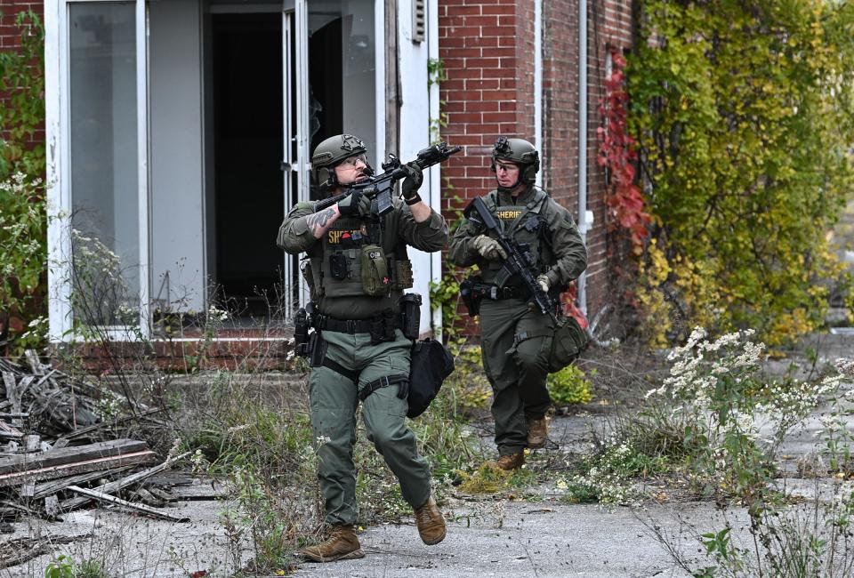 Officers with the Frederick County Sheriff's Department SWAT Team search for suspect Pedro Argote at the former Garden State Tannery plant northwest of Williamsport on Saturday. Argote is the suspect in the killing of Washington County Circuit Court Judge Andrew Wilkinson.