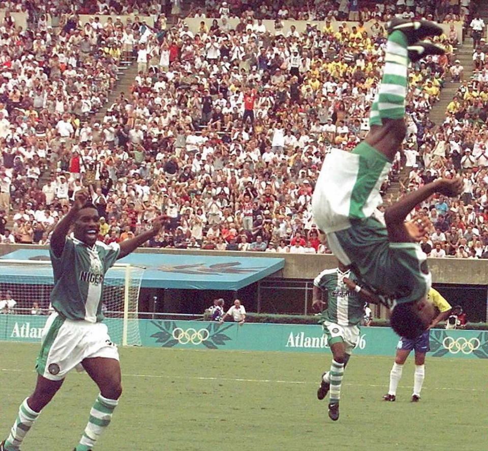 Nigeria's Celestine Babayaro (R) makes a flip after scoring a goal against Brazil during the Olympic soccer semi-final Brazil vs Nigeria in Athens, Ga., on July 31, 1996. Nigeria won 4-3.<span class="copyright">Gabriel Bouys—AFP via Getty Images</span>