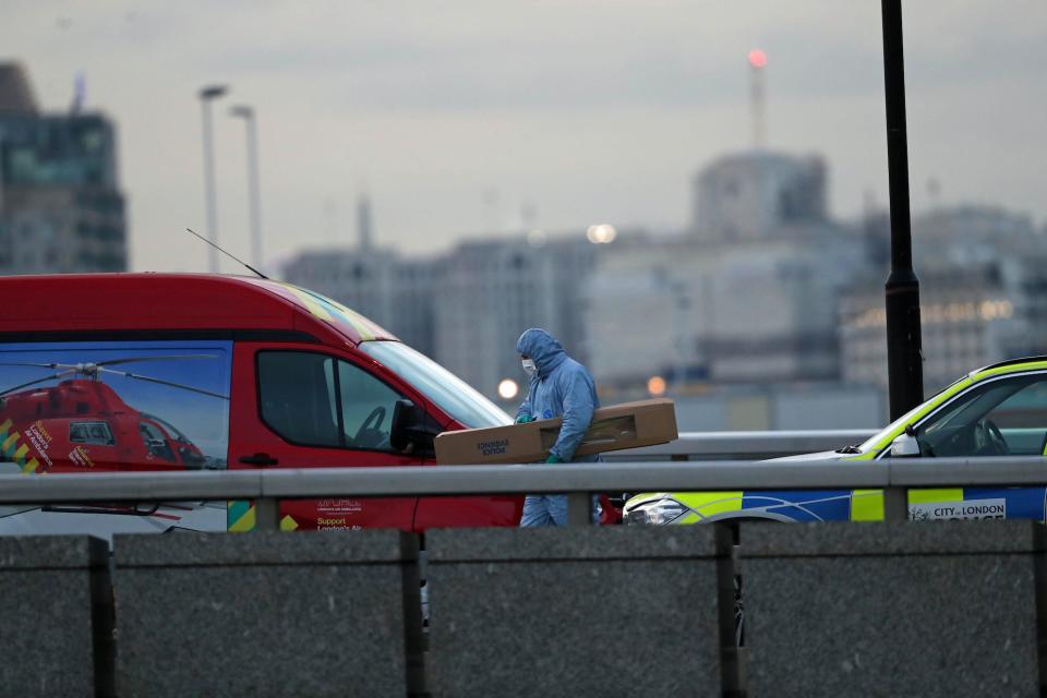 A forensic officer holding an evidence box, with what appears to be part of the narwhal tusk, on London Bridge in central London after a terrorist wearing a fake suicide vest who went on a knife rampage killing two people, was shot dead by police.