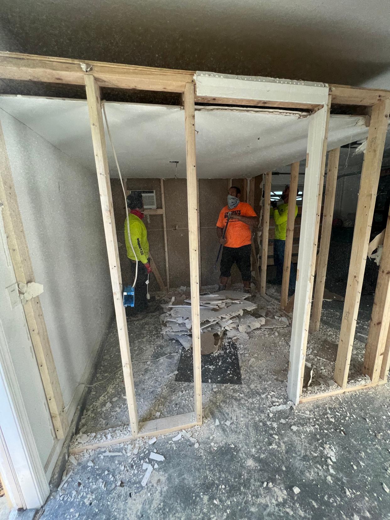 Photos provided to The Palm Beach Post show the demolition of a garage room where Timothy and Tracy Ferriter are accused of locking their 14-year-old adopted child for up to 18 hours at a time.